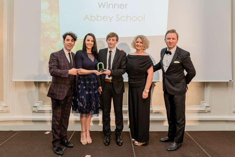 Pete Firman, Comedian and Magician, with representatives from Abbey School and Nursery World's commercial director Tom Curtiss
