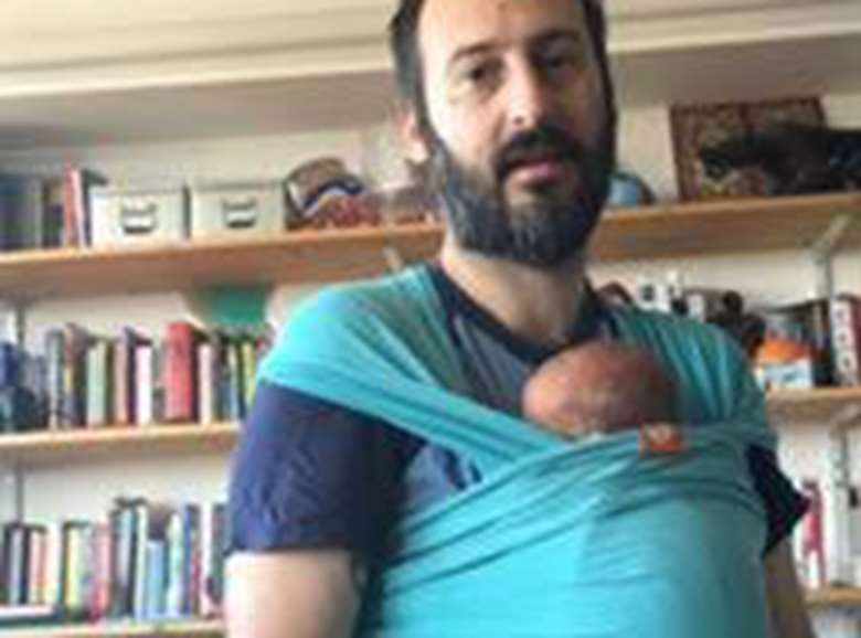 Claudio Deola, picured with his newborn baby girl, is one of the first of Save the Children's employees to benefit from the charity's increase to paid paternity leave