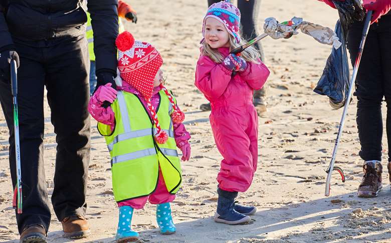 Children from Tops Day Nurseries clean up a local beach