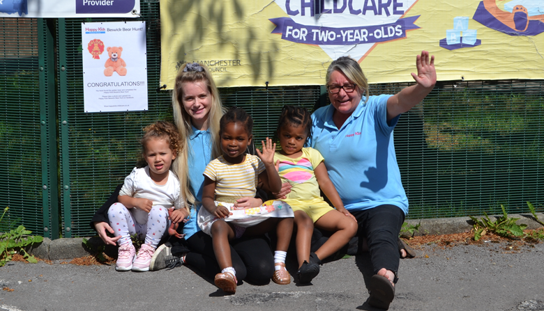Manager Tina McGillian and practitioner Charlotte Jarvis with children and the golden bear