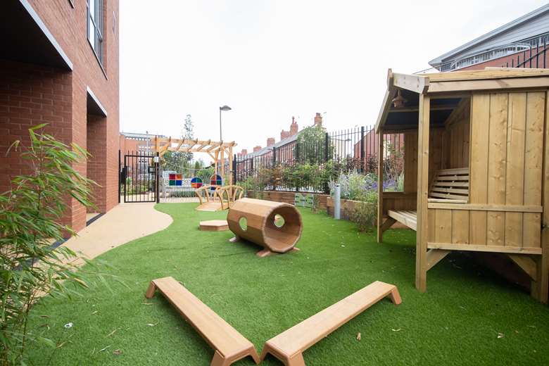 The outdoor area of the nursery is next door to the care village garden and was designed so that children and residents can talk across the fence