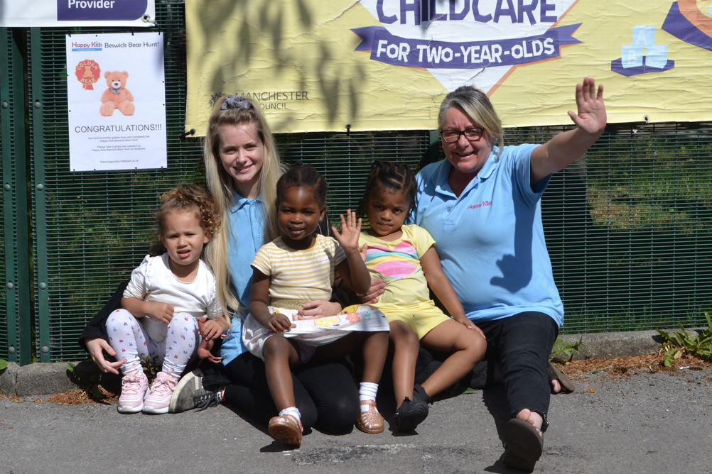 Manager Tina McGillian and practitioner Charlotte Jarvis with children and the golden bear