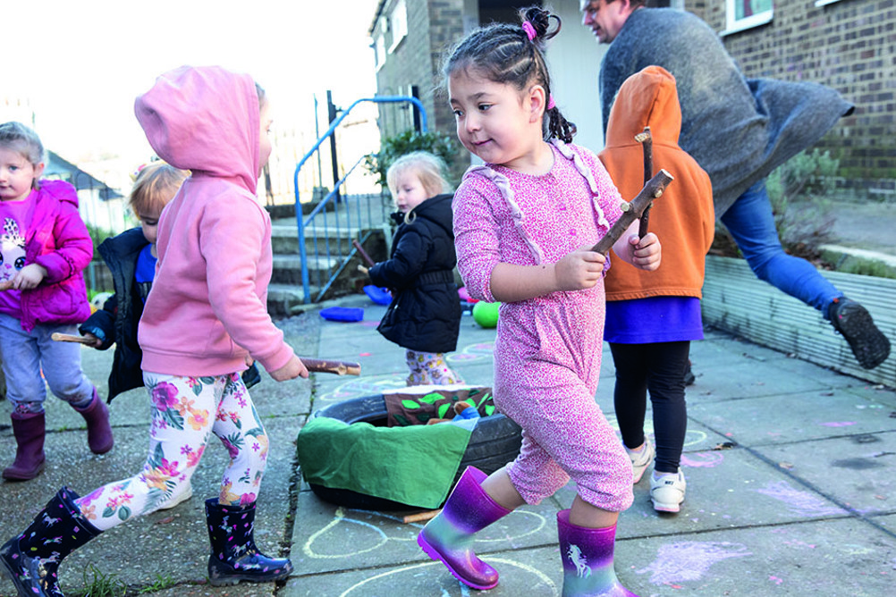 At Ore Church Mice Preschool, children use sticks to tap out rhythms and use items such as cable reels for rolling to each other